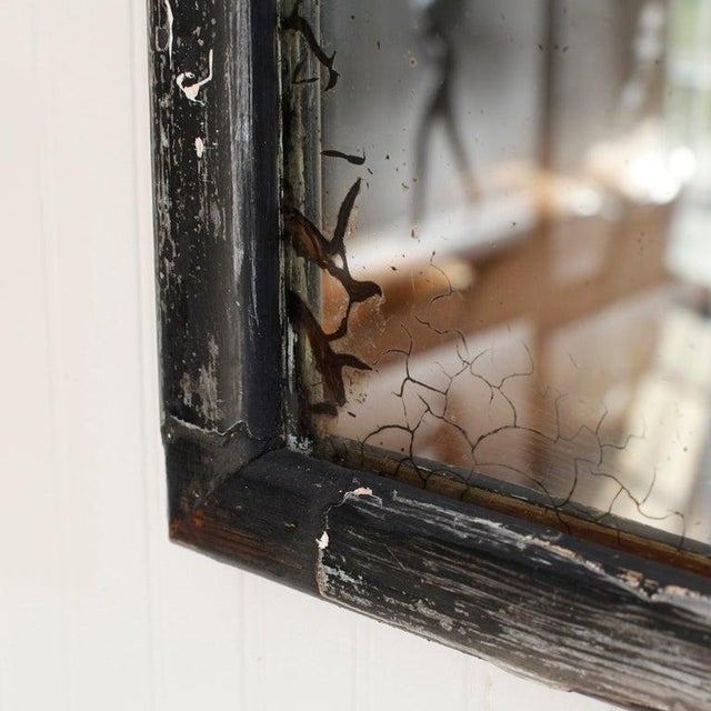 Set of four early 19th century mirrors. Black paint is peeling to reveal antique paint layers & wood. Silver is peeling...