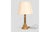 Elegant vintage table lamp featuring a turned brass base and an ivory fabric lampshade. The golden metal structure, with...