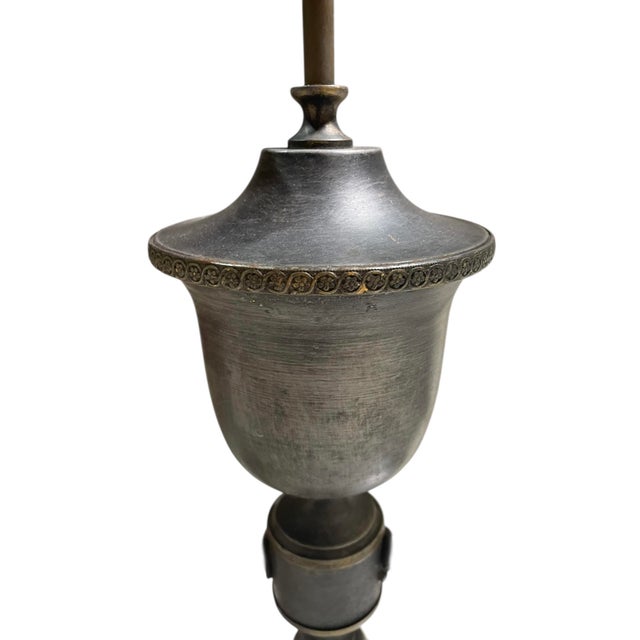 Masculine early 1900s Bouillotte metal table lamp. It offers two light candelabras with tall lead glass hurricanes. The...
