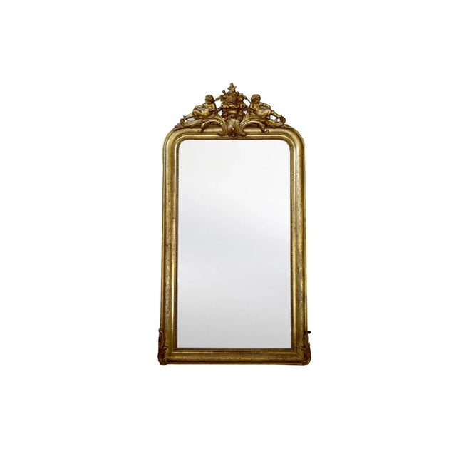 Gold Leaf Louis Philippe mirror with angel cartouche. Made in the 19th Century.