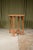 A craftsman made Cotswold School circular table, with a veneered pale oak top on four stop chamfered legs united by a...
