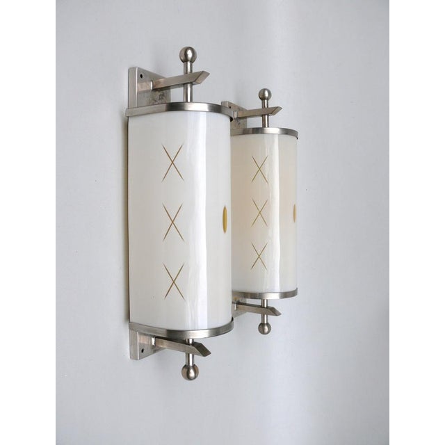 A few elegant wall lights in the typically strict formal language of Art Deco. The lamp umbrellas are made of overfucking...