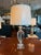 A solid crystal urn table lamp from Haig featuring a faceted urn-form body and a clear crystal square base. The elegant...