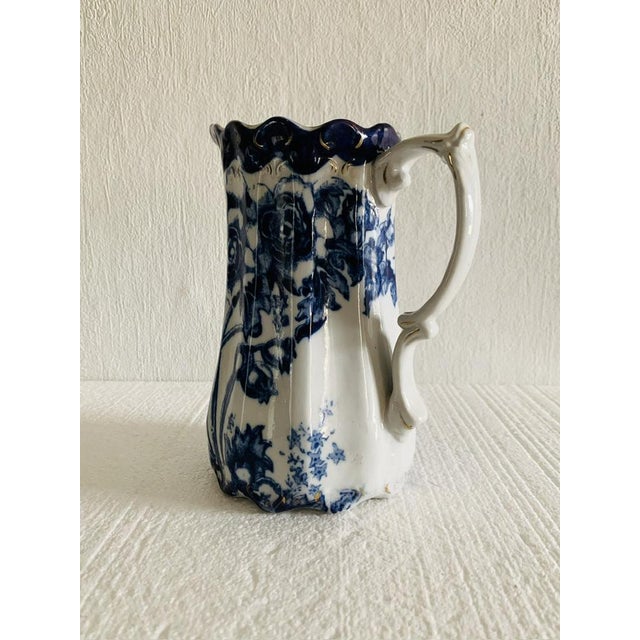 Beautiful, flow blue antique pitcher/jug, by Doulton Burslem, circa 1890's. Piece has been designed between 1862 - 1902....