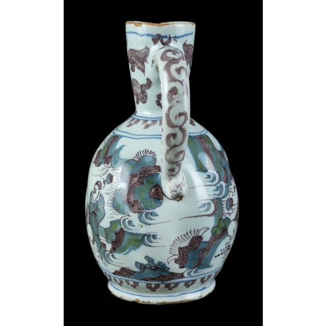 Polychrome chinoiserie wine jug Delft, circa 1680 The polychrome wine jug has an ovoid and turned body on a low spreading...