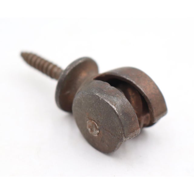 Antique bronze and black finish cast iron recessed window sash pulleys used for double hung windows. There are wood screws...