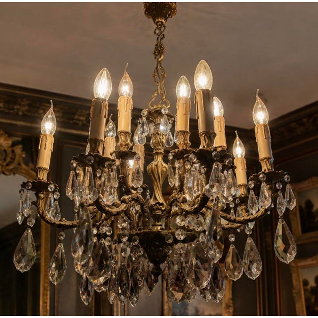 Exceptional french louis xv / rococo style chandelier featuring sixteen light points and an elaborately cast gilt bronze...