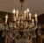 Exceptional french louis xv / rococo style chandelier featuring sixteen light points and an elaborately cast gilt bronze...