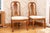 A pair of 18th century Queen Anne style upholstered walnut carved side chairs with a baluster form back splat, scrolled...