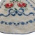 "A darling vintage apron, hand-embroidered with bright red roses, blue bows, and a full border of tiny cross-stitches....