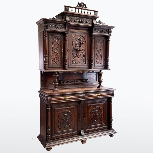 An impressive Historicist sideboard featuring rich carved decoration and strong architectural presence. The piece...