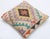 A one-of-a-kind handwoven Afghan wool kilim accent pillow featuring central diamond medallion on a pastel zigzag field....