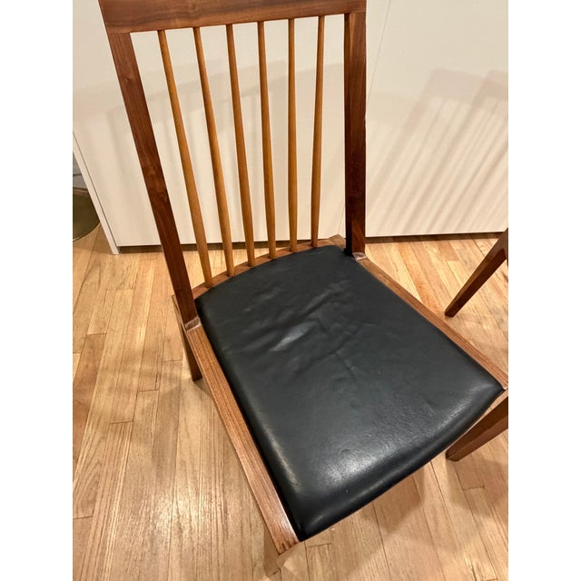Pair of Organic Modernism Brooklyn, NY dining chairs. Walnut and black leather seats. Good condition