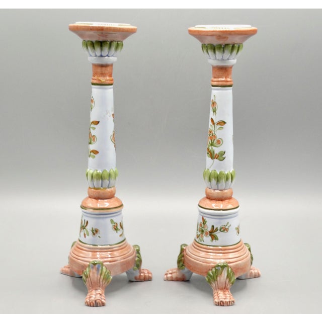 Lovely pair of Italian faience candle holders hand with a floral motif raised on a trio of paw feet. They are hand painted...