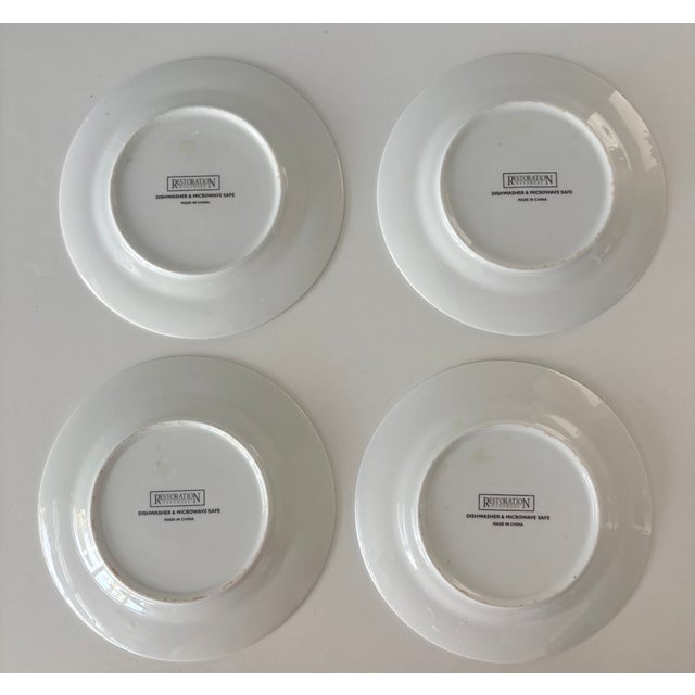 This set of four vintage Restoration Hardware appetizer plates feature artwork of four gourmet European cheeses and the...