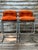 Pair of 1970’s ISO Jerry Johnson chrome barstools with original orange nubby upholstered seats. There are no markings to...