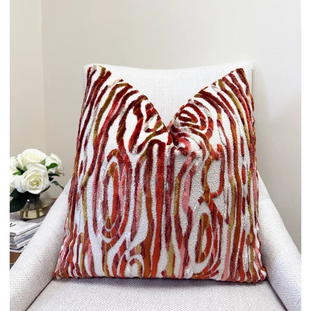 Make a bold statement with this designer velvet pillow, showcasing a raised cut velvet pattern in vivid shades of red,...