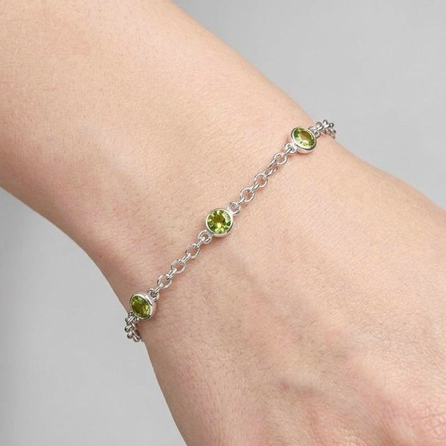 Delicate, fresh, and effortlessly elegant, this bracelet features vibrant green gemstones set along a fine silver...
