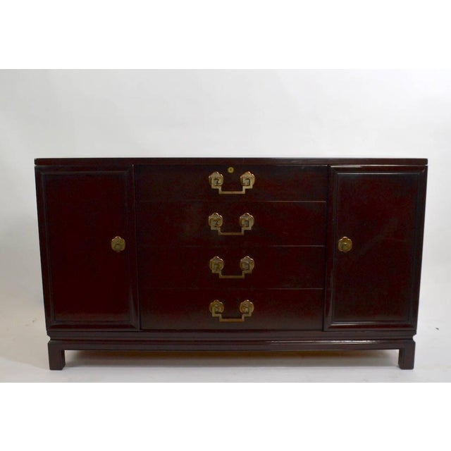 Asia Modern sideboard manufactured by recognized furniture company Landstrom Furniture Corporation. Two doors open to...