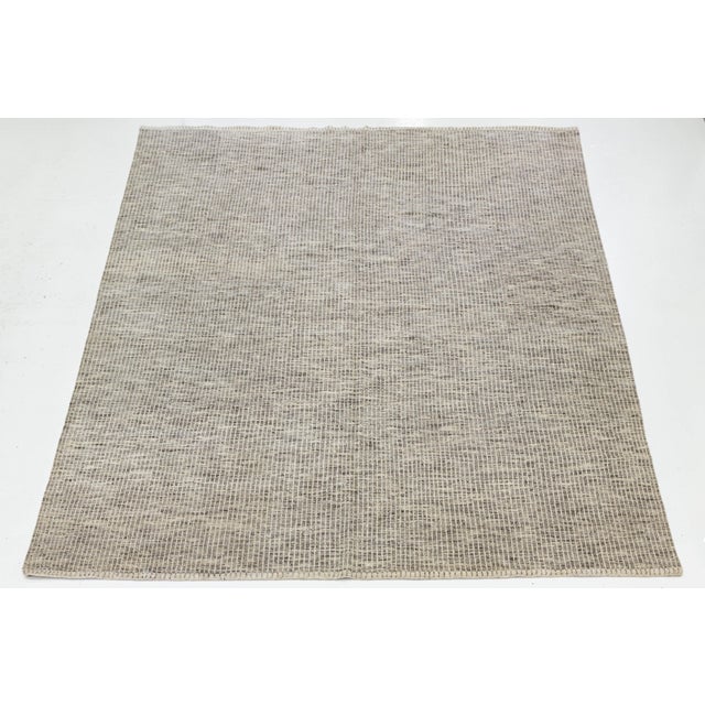 Elevate your living space with this sophisticated Modern Moroccan-style wool rug. Blending traditional craftsmanship with...