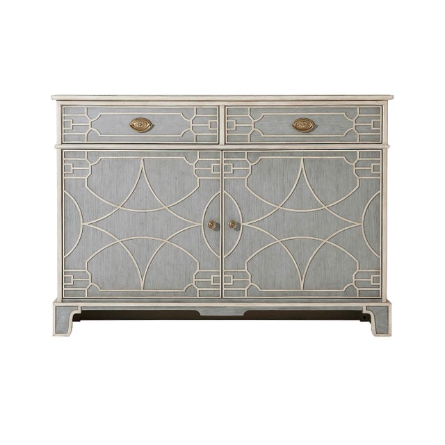 A vintage painted Chinese Chippendale style side cabinet with two blind fret carved frieze drawers with brass pull handles...
