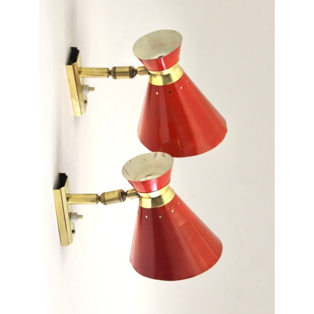 These articulated wall lights were probably designed by Rene Mathieu and produced by Lunel in France. It has a double cone...