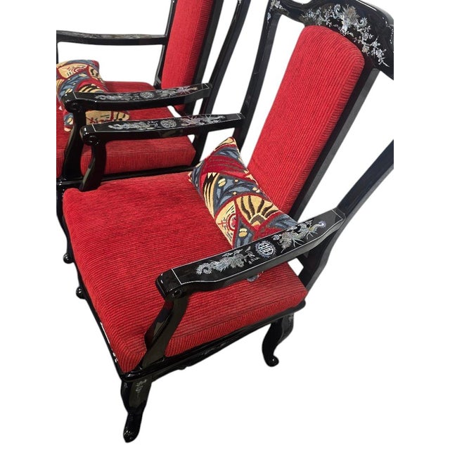 A striking pair of Asian-inspired black lacquer armchairs featuring intricate mother-of-pearl inlay. Each chair showcases...
