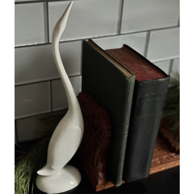 A graceful mid-century ceramic crane by B. Brenner, finished in a soft ivory glaze. Sculptural and refined.