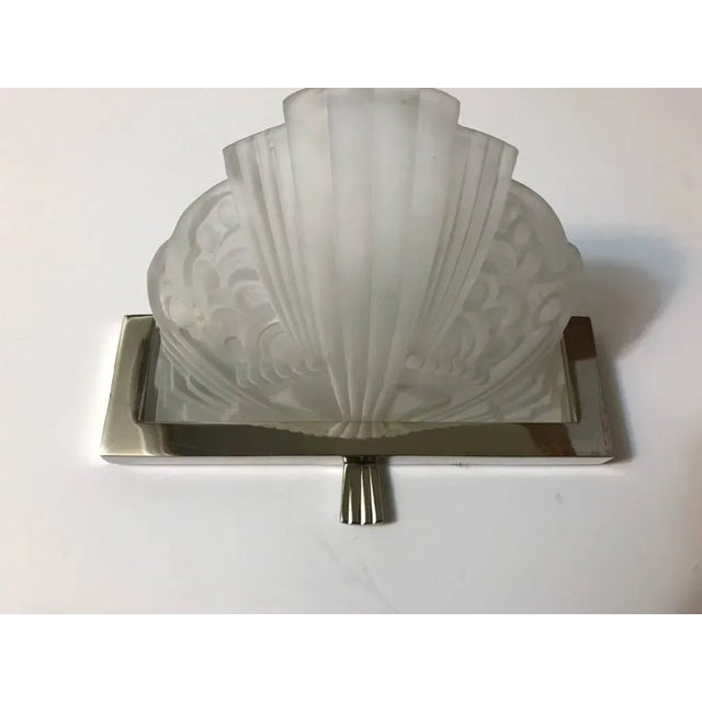 Stunning pair of French Art Deco sconces by G Leleu. With clear frosted glass shades with intricate geometric motif...