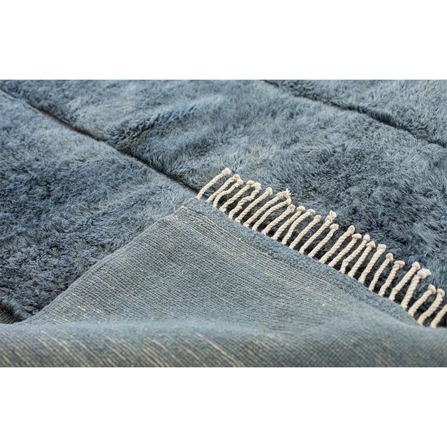 Timeless hand-knotted wool rug in soft Slate Grey tones with a plush, textured surface and subtle vertical divisions. Its...