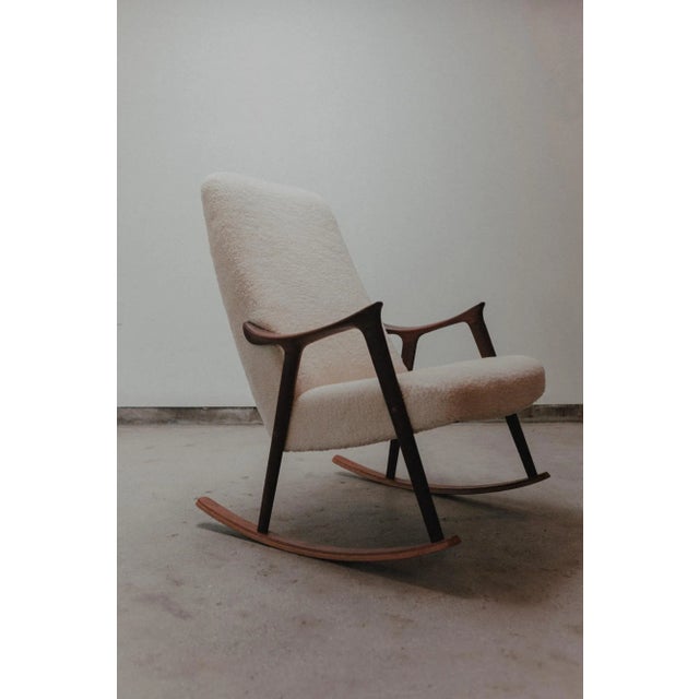 Mid Century Rocking Chair By Igmar Relling for Westnova Sculpted Solid Teak Newly Upholstered in 100% natural sheepskin.