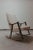 Mid Century Rocking Chair By Igmar Relling for Westnova Sculpted Solid Teak Newly Upholstered in 100% natural sheepskin.