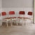 A four-piece chair set, made in Germany in the 1960s, with a cream-white lacquered frame and red molded plywood seats and...