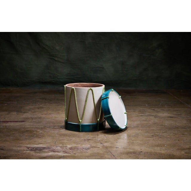 Italian Trompe l'Oeil Drum Garden Table features a ceramic design that mimics a traditional drum with detailed green rope...