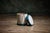 Italian Trompe l'Oeil Drum Garden Table features a ceramic design that mimics a traditional drum with detailed green rope...