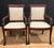 Pair of early 20th century hand carved mahogany armchairs with dolphin form arms. Fan design satinwood inlay on top rails....