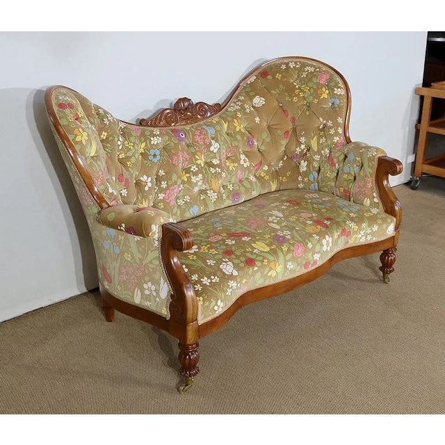 Charming birch sofa with curved forms and a large upholstered back with two pronounced lateral ears and a hollowed out...