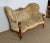 Charming birch sofa with curved forms and a large upholstered back with two pronounced lateral ears and a hollowed out...
