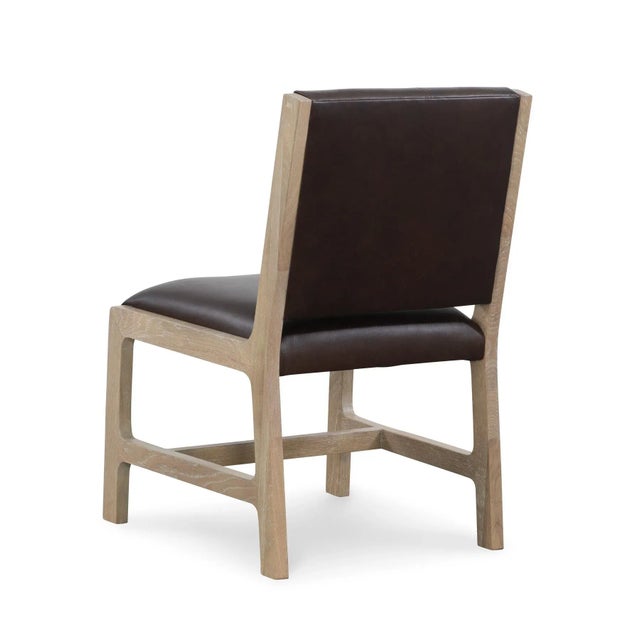 Cerused white oak dining chair with chocolate brown trapunto stitched leather seat back.