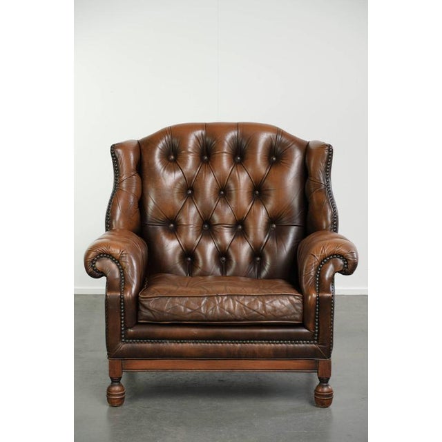 This vintage cowhide Chesterfield wing armchair is crafted in an English style and boasts a luxurious look. The armchair...