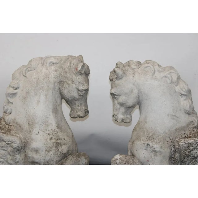 Antique beautifully weathered cast stone garden statues in the classical Greek form of Pegasus. They are a rare right and...
