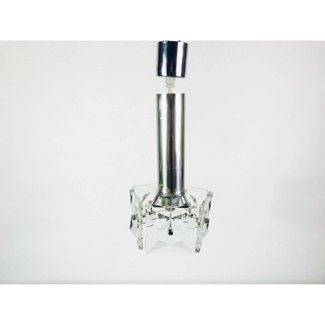 A Kinkeldey ice glass chandelier made in Germany in the 1960s. The light is made of an aluminium body and five ice glass...