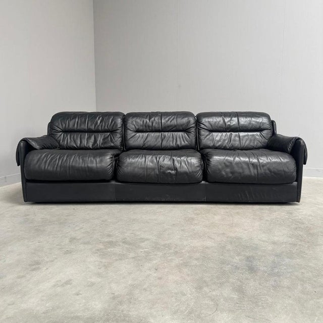 Remarks: Mid century sofa by Dreipunkt, Germany 1970s. Strong and heavy wooden frame with black leather upholstery. All...