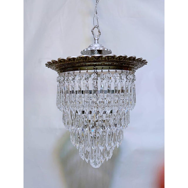 Italian layered chandelier with silver plated rim and 30% leaded U-drop crystal drops. It has 1 edison base socket that...