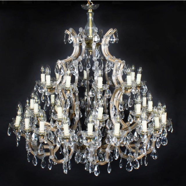 This is a beautiful pair of English Ballroom crystal chandeliers each with forty-one lights arranged over three tiers, and...
