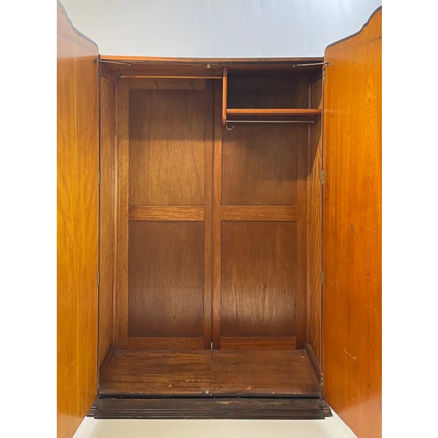 A great example of English Art Deco cabinetry, this wardrobe features mesmerizing book-matched burl walnut doors with a...