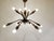 Elegant copper spider or sputnik chandelier with cut glass details. The light shades have a 'curled' finish and the...