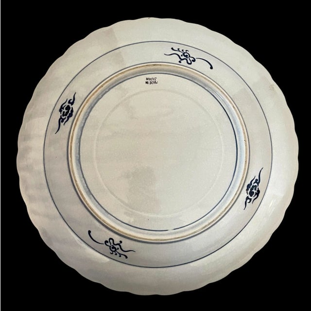 This vintage Japanese Imari plate is a large 16-inch serving or decorative piece made of porcelain and pottery....