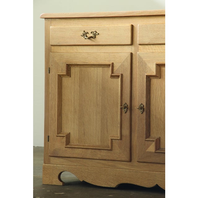 This Danish Brutalist sideboard in solid Nordic oak is often attributed to Henning Kjærnulf and made in Denmark during the...