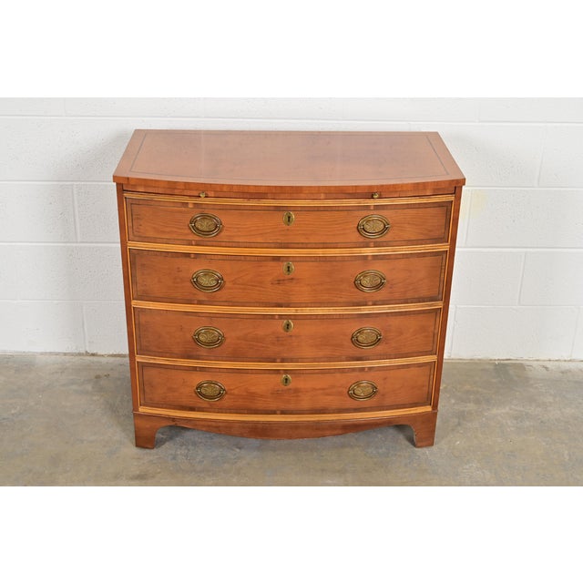 An exceptional Georgian or Chippendale style bow front dresser, buffet server, or chest of drawers By Baker Furniture USA,...